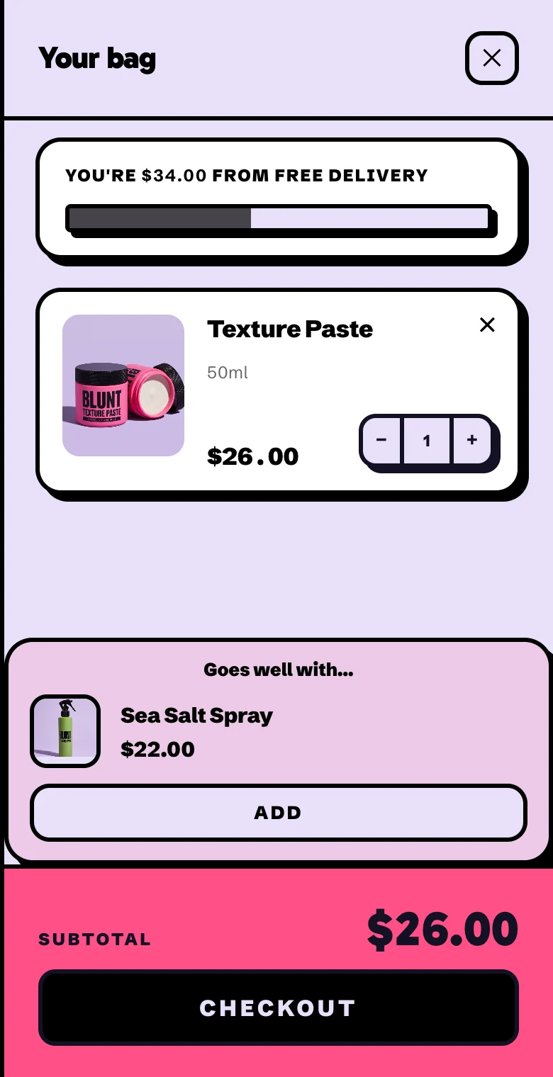 A cart with one tub of texture paste and a Goes well with box above the subtotal, offering the sea salt spray at $22 with an Add button