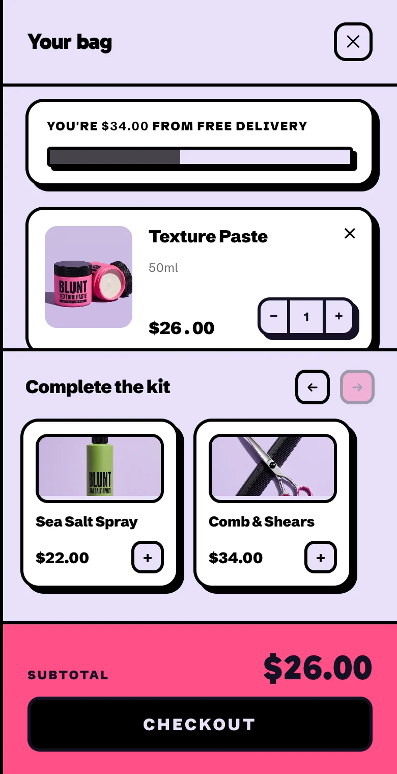 A cart with one tub of texture paste and a Complete the kit shelf showing the sea salt spray and the comb and shears, each with a plus button